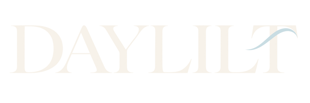 Daylilt wordmark in warm pearl with a mist blue silk fold